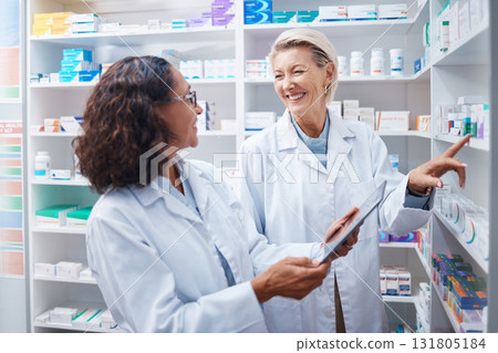 Doctors, tablet and pharmacist check stock in pharmacy, drugstore or medication shop. Medicine, technology and medical teamwork of happy senior women with touchscreen for checking product inventory. Doctors, tablet and pharmacist check stock in pharmacy, drugstore or medication shop. Medicine, technology and medical teamwork of happy senior women with touchscreen for checking product inventory. 131805184