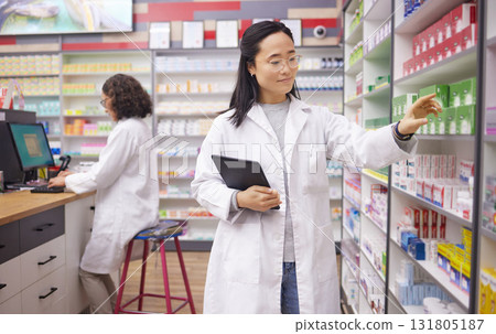 Pharmacy, tablet and pharmacist woman for medicine management, stock research and inventory data app. Digital technology, retail logistics and asian healthcare doctor or person for product data check 131805187