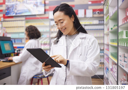 Pharmacy, tablet and asian pharmacist woman for medicine management, stock research and inventory. Digital technology, retail logistics and healthcare doctor or person with ecommerce product software Pharmacy, tablet and asian pharmacist woman for medicine management, stock research and inventory. Digital technology, retail logistics and healthcare doctor or person with ecommerce product software 131805197