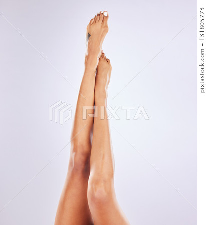 Body care, epilation and closeup of legs in a studio with a hair removal, waxing or shaving routine. Wellness, health and woman model with grooming, self care and beauty treatment by gray background. Body care, epilation and closeup of legs in a studio with a hair removal, waxing or shaving routine. Wellness, health and woman model with grooming, self care and beauty treatment by gray background. 131805773