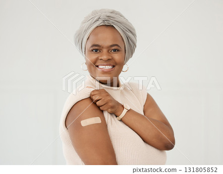 Black woman, smile and covid plaster on arm in studio for injection with medical insurance. Portrait of African female happy on a white background with vaccine, safety compliance and mockup space 131805852