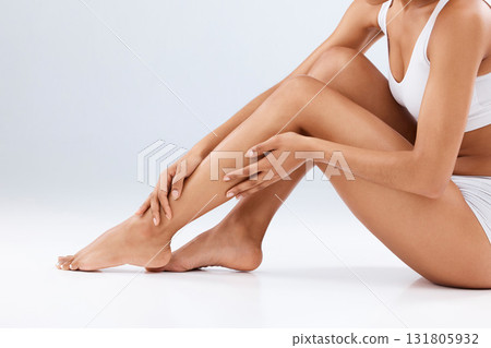 Woman, skincare and beauty legs for wellness, laser hair removal and studio background. Female model, leg and body cosmetics, shine and epilation for salon waxing, aesthetic pedicure and mockup glow Woman, skincare and beauty legs for wellness, laser hair removal and studio background. Female model, leg and body cosmetics, shine and epilation for salon waxing, aesthetic pedicure and mockup glow 131805932