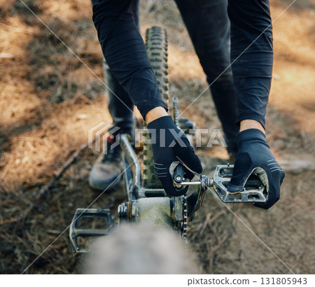 Hands, bicycle and repair pedal in woods for speed, dirt and nature in summer for extreme sport athlete. Man, Mountain bike expert and outdoor for workout, training and exercise in forest Hands, bicycle and repair pedal in woods for speed, dirt and nature in summer for extreme sport athlete. Man, Mountain bike expert and outdoor for workout, training and exercise in forest 131805943