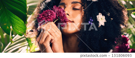 Flowers, beauty and scent by woman in studio for wellness, skincare and creative advertising in jungle. Face, skin and girl model relax in zen, peace and product from nature, forest and aesthetic 131806093