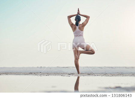 Rear view, balance pose and yoga by woman at the beach for wellness, zen and peace against ocean mockup. Back, standing and meditation by girl at the sea for energy, exercise and fitness workout Rear view, balance pose and yoga by woman at the beach for wellness, zen and peace against ocean mockup. Back, standing and meditation by girl at the sea for energy, exercise and fitness workout 131806143