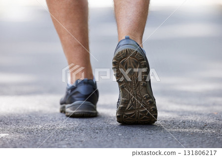 Fitness, shoes and walking with a man on a street during a cardio or endurance workout outdoor. Back, exercise and health with a male runner or athlete training on a street for wellness or lifestyle Fitness, shoes and walking with a man on a street during a cardio or endurance workout outdoor. Back, exercise and health with a male runner or athlete training on a street for wellness or lifestyle 131806217