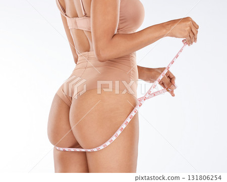 Diet, progress and butt of woman with tape measure to track weight loss transformation, fitness model or health goals. Body back view, wellness lifestyle and self care girl check liposuction results Diet, progress and butt of woman with tape measure to track weight loss transformation, fitness model or health goals. Body back view, wellness lifestyle and self care girl check liposuction results 131806254