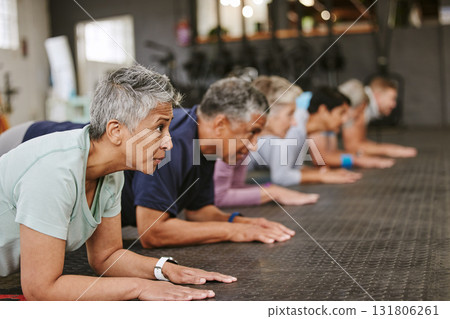 People, fitness and plank in class for workout, core exercise or training together at indoor gym. Diverse group or team in warm up ab muscle session for sport, health or wellness on gymnasium floor 131806261