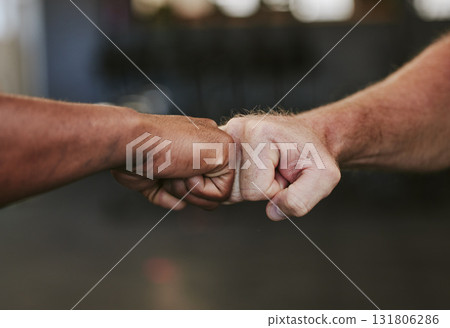 Fist bump, hands and fitness motivation for sports, greeting or team building in gym for wellness. Athlete people, exercise partnership or support, agreement and collaboration, success or teamwork. Fist bump, hands and fitness motivation for sports, greeting or team building in gym for wellness. Athlete people, exercise partnership or support, agreement and collaboration, success or teamwork. 131806286