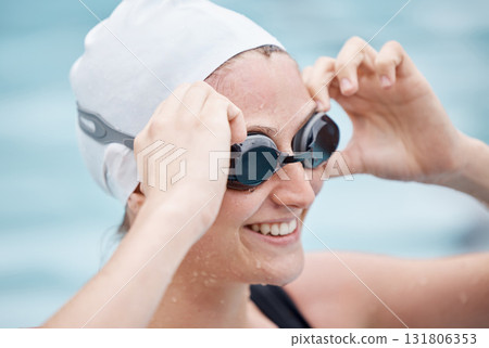 Training, sports or happy woman in swimming pool or water for practice, workout or body fitness. Wellness, smile or healthy girl athlete in goggles exercising for cardio, endurance or exercise goals Training, sports or happy woman in swimming pool or water for practice, workout or body fitness. Wellness, smile or healthy girl athlete in goggles exercising for cardio, endurance or exercise goals 131806353