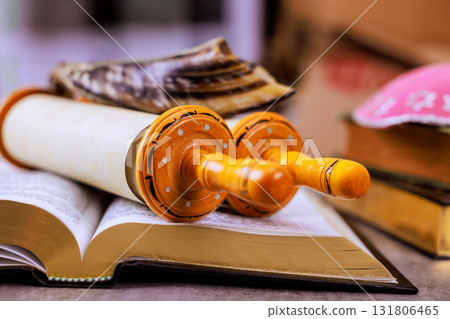 During Jewish holiday Rosh Hashanah with Torah scroll religious texts shofar on table create atmosphere 131806465