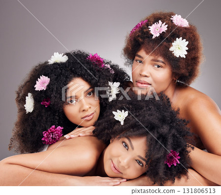 Hair care, friends and portrait of black women with flowers in studio isolated on gray background. Floral cosmetics, organic makeup and face of group of girls with flower for beauty and aesthetic. 131806513