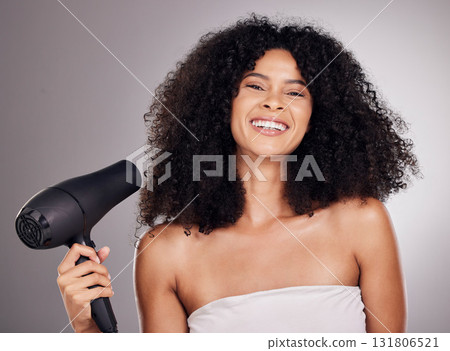 Beauty, portrait and black woman with hair dryer in studio isolated on gray background. Haircare, face and happy female model with machine to dry hairstyle after salon treatment for growth or texture 131806521