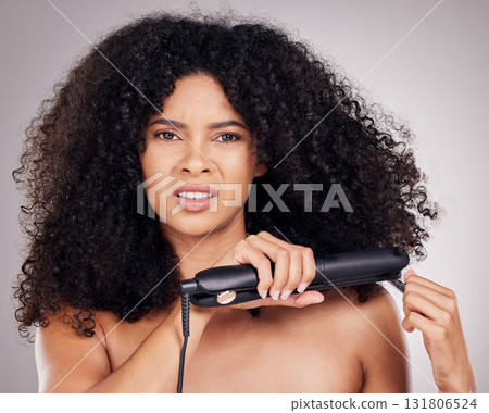 Face portrait, sad and woman with hair straightener in studio isolated on gray background. Haircare damage, hairloss and black female model angry with flat iron for hairstyle after salon treatment. Face portrait, sad and woman with hair straightener in studio isolated on gray background. Haircare damage, hairloss and black female model angry with flat iron for hairstyle after salon treatment. 131806524