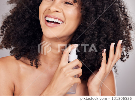Beauty, hair and hands of black woman spray for natural wellness, growth and glow on gray background. Self care, salon and happy girl smile with hairspray, cosmetic products and keratin treatment Beauty, hair and hands of black woman spray for natural wellness, growth and glow on gray background. Self care, salon and happy girl smile with hairspray, cosmetic products and keratin treatment 131806526