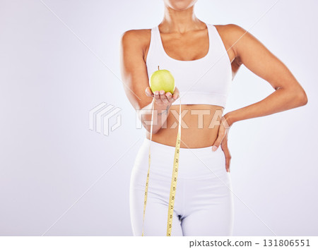 Health, apple and tape measure for diet of woman in studio for healthy lifestyle, weight loss or fitness. Female on a white background for health, wellness and fruit motivation for healthcare goals 131806551