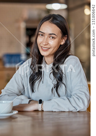Cafe, relax and portrait of woman with coffee in restaurant with hot beverage, cappuccino and latte drink. Happy, smile and face of real girl sitting by table for relaxation and happiness on weekend Cafe, relax and portrait of woman with coffee in restaurant with hot beverage, cappuccino and latte drink. Happy, smile and face of real girl sitting by table for relaxation and happiness on weekend 131806642