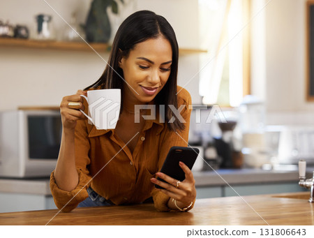 Kitchen, counter and woman with phone, coffee and smile while browsing internet, checking social media or reading email. Chat, connect and relax, happy latino person networking on break in apartment. 131806643