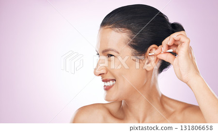 Woman, cotton and clean ear in studio with happiness for wellness, health and pink background. Model hand, self care and cleaning for hygiene, earwax and natural product with smile by background 131806658