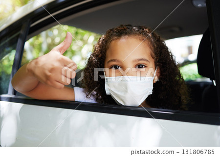Covid, thumbs up and portrait of a girl in a car for travel, road trip safety and compliance. Free, satisfaction and a little child showing a hand gesture with a face mask for protection in transport Covid, thumbs up and portrait of a girl in a car for travel, road trip safety and compliance. Free, satisfaction and a little child showing a hand gesture with a face mask for protection in transport 131806785