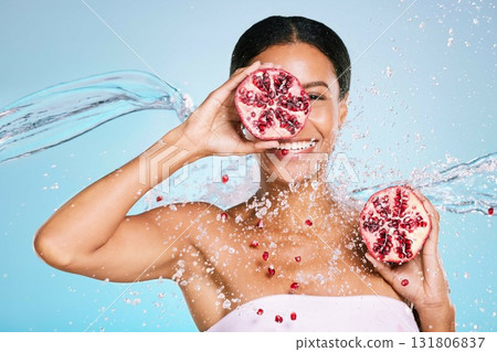 Pomegranate, skincare and woman portrait with beauty and healthy skin or diet on blue background. Face of aesthetic model person with water splash and fruit for sustainable facial health and wellness Pomegranate, skincare and woman portrait with beauty and healthy skin or diet on blue background. Face of aesthetic model person with water splash and fruit for sustainable facial health and wellness 131806837
