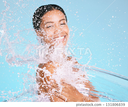 Water, splash and black woman cleaning her body for beauty, skincare and self care isolated in studio blue background. Portrait, model and young female washing skin for hygiene, aqua and hydration 131806839