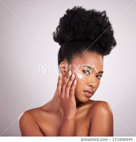 Black woman, face and moisturizer cream for skincare beauty or cosmetics against a gray studio background. Portrait of African American female applying moisturizing creme, lotion or facial product 131806845