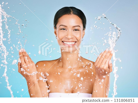 Portrait, black woman and water for cleaning, dermatology and smile with wellness, health and blue studio background. Face detox, African American female and happy lady with liquid, aqua and skincare Portrait, black woman and water for cleaning, dermatology and smile with wellness, health and blue studio background. Face detox, African American female and happy lady with liquid, aqua and skincare 131806851