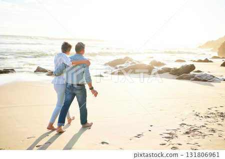 Beach, love and mockup with a senior couple walking on the sand by the ocean or sea for sunset romance. Nature, summer or back with a mature woman and man taking a romantic walk together on the coast 131806961