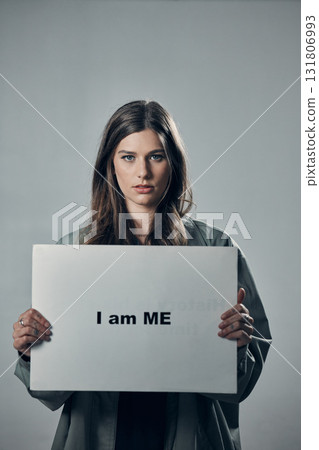 Woman, protest and poster in pride for self esteem, equality or human rights against gray studio background. Portrait of confident female activist with I am me message on board for unique empowerment 131806993