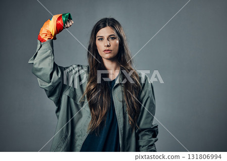 Woman, protest and rainbow fist for gay, LGBTQ or human rights against gray studio background. Portrait of female activist standing ready in fighting for equality, empowerment or sexuality on mockup Woman, protest and rainbow fist for gay, LGBTQ or human rights against gray studio background. Portrait of female activist standing ready in fighting for equality, empowerment or sexuality on mockup 131806994