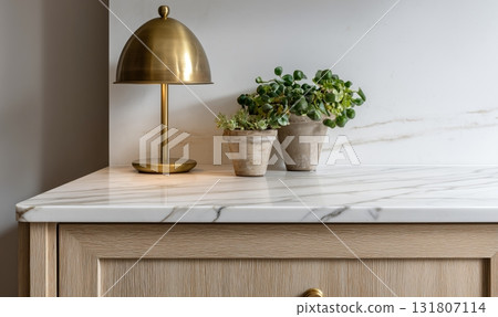 Modern Interior Design Featuring a Stylish Lamp and a Potted Plant on a Marble Countertop Modern Interior Design Featuring a Stylish Lamp and a Potted Plant on a Marble Countertop 131807114