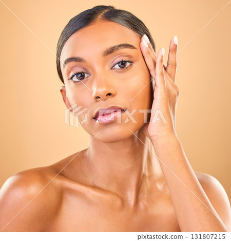 Skincare, face portrait and beauty of woman in studio isolated on brown background. Makeup, serious cosmetics and confident Indian female model with spa facial treatment for healthy or flawless skin. Skincare, face portrait and beauty of woman in studio isolated on brown background. Makeup, serious cosmetics and confident Indian female model with spa facial treatment for healthy or flawless skin. 131807215