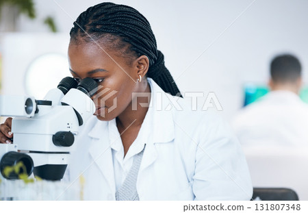 Medical science, black woman and microscope in laboratory for research, analytics and medicine. Woman, doctor and scientist study at work for an investigation, healthcare and futuristic mock up space Medical science, black woman and microscope in laboratory for research, analytics and medicine. Woman, doctor and scientist study at work for an investigation, healthcare and futuristic mock up space 131807348