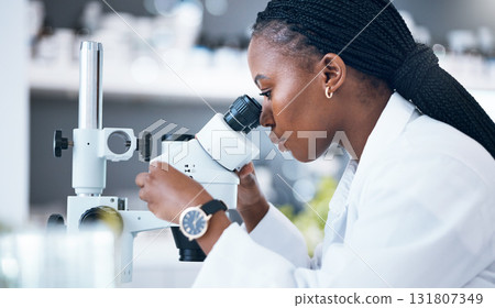Black woman, medical science and microscope in laboratory for research, analytics and medicine. Woman, doctor and scientist study at work for an investigation, healthcare and futuristic or innovation Black woman, medical science and microscope in laboratory for research, analytics and medicine. Woman, doctor and scientist study at work for an investigation, healthcare and futuristic or innovation 131807349