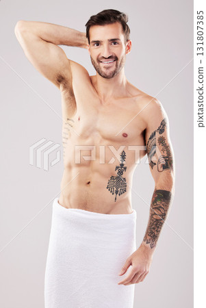 Clean, body and portrait of a man from the shower isolated on a grey studio background. Hygiene, grooming and happy shirtless model with a towel after a wash for a morning routine on a backdrop Clean, body and portrait of a man from the shower isolated on a grey studio background. Hygiene, grooming and happy shirtless model with a towel after a wash for a morning routine on a backdrop 131807385