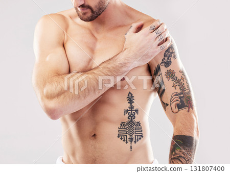 Injury, shoulder and man with arm pain and body stress isolated on a grey studio background. Heart attack, accident and injured person feeling a painful, swollen and inflamed muscle on a backdrop 131807400