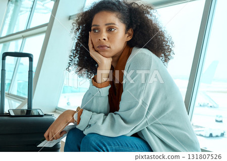 Airport, flight delay and depressed woman sad for immigration fail, passport or schedule problem. Young USA person with luggage and ticket with stress, anxiety and thinking of airplane travel crisis 131807526