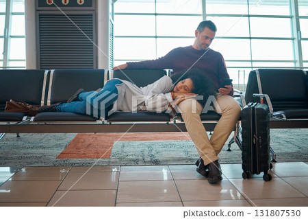 Airport, sleeping woman and couple waiting for airplane for holiday travel together.Tired, flight delay and luggage of people going on a international vacation journey with suitcase on a chair Airport, sleeping woman and couple waiting for airplane for holiday travel together.Tired, flight delay and luggage of people going on a international vacation journey with suitcase on a chair 131807530