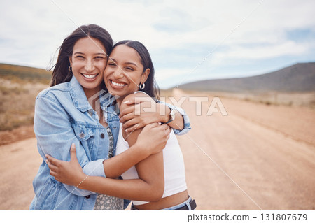 Portrait, hug and friends on a road trip with mockup on a dirt road outdoor in nature for adventure together. Desert, travel or freedom with a young woman and friend hugging outsode on holiday Portrait, hug and friends on a road trip with mockup on a dirt road outdoor in nature for adventure together. Desert, travel or freedom with a young woman and friend hugging outsode on holiday 131807679