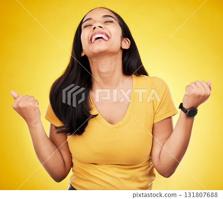 Woman, happy and fist of winner in studio for celebration, achievement deal and lotto success. Excited female model celebrate winning prize on yellow background for lottery, bonus victory and smile Woman, happy and fist of winner in studio for celebration, achievement deal and lotto success. Excited female model celebrate winning prize on yellow background for lottery, bonus victory and smile 131807688