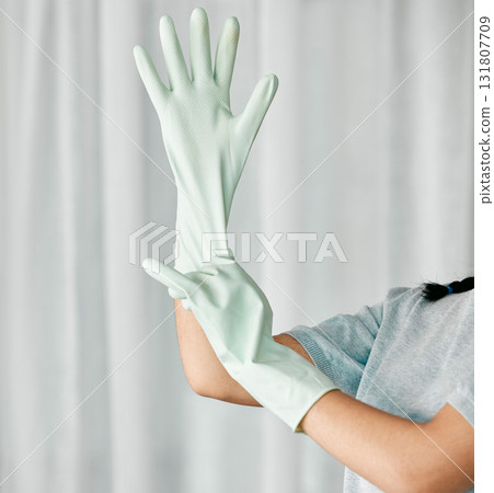 Cleaning gloves, hands and woman in a home ready to start bacteria and mess removal for safety. House, cleaner and maintenance of a female housekeeping employee with rubber glove for clean household 131807709
