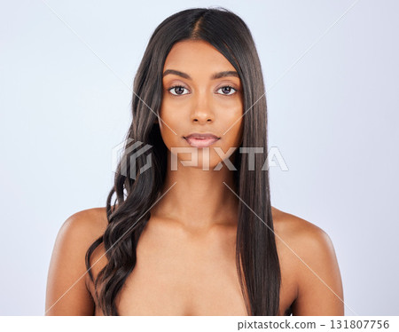 Girl, hair care or beauty in studio portrait for strong, healthy natural shine or wellness on white background. Face of glowing young model, Indian woman or salon spa for curly style in grooming 131807756