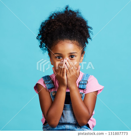 Children, portrait and wow with a girl on a blue background in studio looking surprised or in shock. Face, hands and gossip with a cute little female child reacting to good news or an announcement 131807773