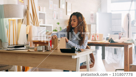 Shipping, package and woman in a small business with ecommerce, logistics and delivery of product or box in startup. Packing, order and employee at table check supply chain, stock or distribution Shipping, package and woman in a small business with ecommerce, logistics and delivery of product or box in startup. Packing, order and employee at table check supply chain, stock or distribution 131807778
