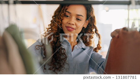 Woman designer, entrepreneur startup and clothes shopping rack in boutique and design studio. Happy worker, purchase and wardrobe of choice, fashion job and professional working in retail store 131807781
