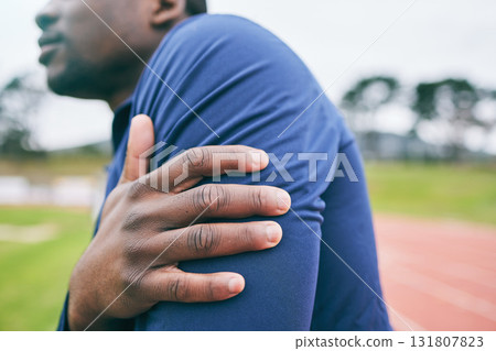 Sports, hands and black man with pain in arm from exercise, workout and marathon training in stadium. Fitness, runner and athlete with joint strain, body injury and medical emergency on running track 131807823