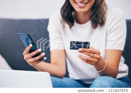 Ecommerce, hands or woman with credit card or phone for a digital payment on sofa relaxing at home. Smile, finance or happy girl online shopping for subscription sales offer, banking or fintech deal Ecommerce, hands or woman with credit card or phone for a digital payment on sofa relaxing at home. Smile, finance or happy girl online shopping for subscription sales offer, banking or fintech deal 131807859