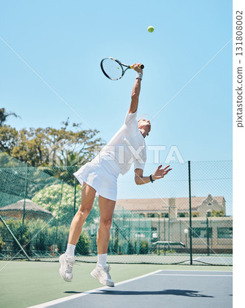 Tennis serve, sports and woman jump on outdoor court, fitness motivation and competition with athlete training for game. Workout, healthy and player on turf, active with sport and exercise action 131808002