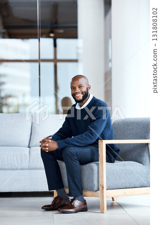 Man, happy and therapist waiting in chair at workplace for consultation or interview in an office building smiling. Portrait, employee and African American worker with positive mindset and excited Man, happy and therapist waiting in chair at workplace for consultation or interview in an office building smiling. Portrait, employee and African American worker with positive mindset and excited 131808102